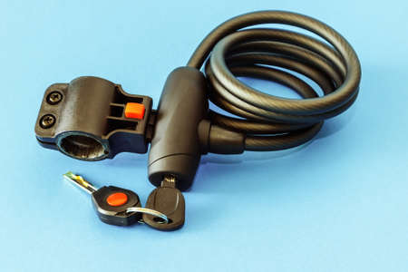 Bicycle lock against theft with keys on a blue background