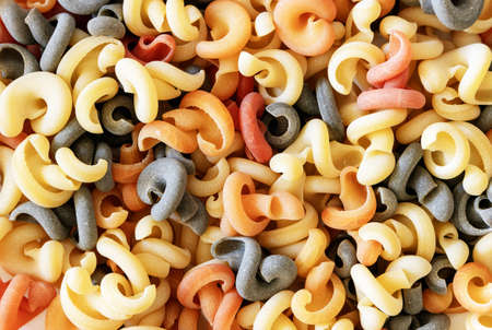 Bunch of Italian green multicolored pasta with tomato and basil flavor, top viewの写真素材