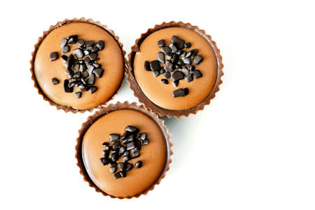 Those chocolate candies with hazelnut and rum-flavored raisin filling, chocolate crumbs isolated on...