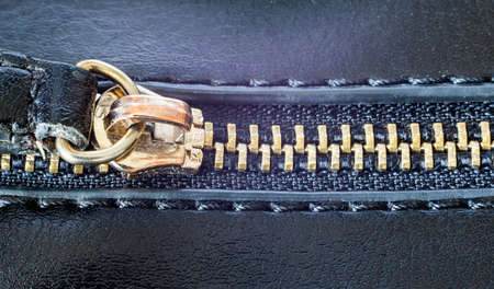 Metal zipper on a dark leather handbag for a close-up view from above