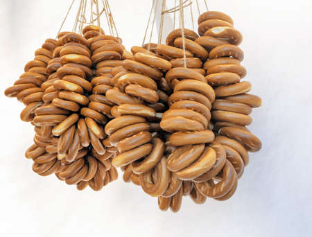 Sweet round rolls strung on a thread hanging outside in a tent