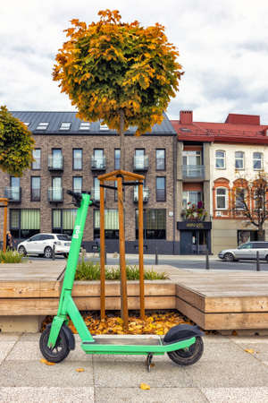 Electric scooter in the city next to wooden buildings in the background. Panevezys Lithuania 4 October 2021のeditorial素材