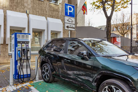 Electric car charging station with electric car in town in autumn. Panevezys Lithuania 5 October 2021のeditorial素材