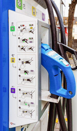 Electric car charging station with instructions for use during the day in the city in autumn....
