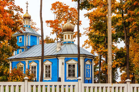 The Orthodox Church is surrounded by trees with autumn leaves. Built in 1892, Period: tsarist, stone masonry plinth, lined with beams. City Panevezys, Lithuania October 5 day 2021の写真素材