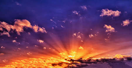 Evening summer sunset with red sunshine in the blue sky