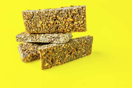 A bunch of oatmeal bars with cocoa on a yellow backgroundの写真素材