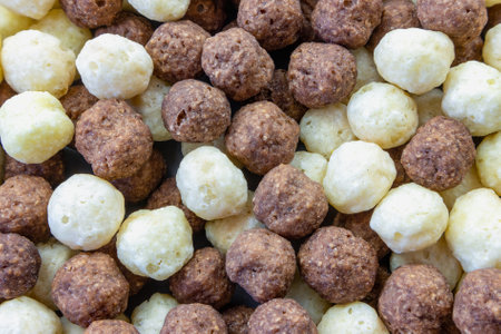Various background of brown and white cocoa and vanilla flavored cornflakes balls top view