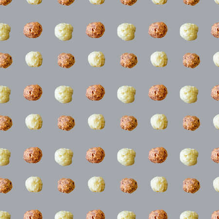 Pattern various cocoa and vanilla flavored cornflakes balls on gray background