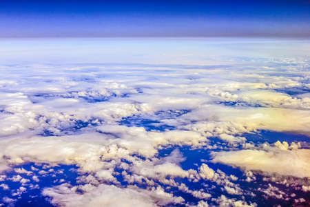 View through an airplane window over a cloud over the Atlantic Oceanの写真素材