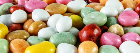 dragees candy multicolored sea pebbles raisins covered with colored caramel, close-up background