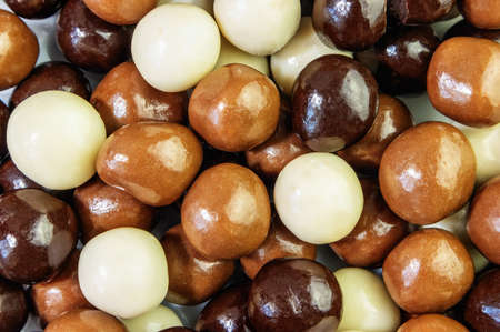 A mixture of crispy chocolate balls with a textured background up closeの写真素材