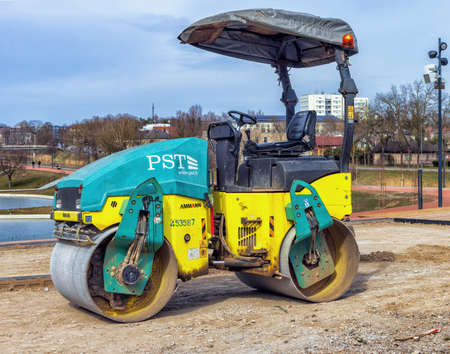 articulated tandem roller Ammann RV110 in the construction of a new park, leveles the ground due to the lift. Panevezys, Lithuania, 15 d. in April 2022のeditorial素材