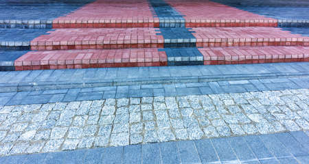 On the outside, the city stairs and pavement are made of colored paving and broken stone, a view...