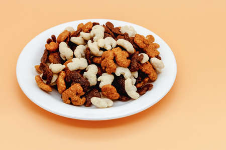 three-tasting dry breakfast for children with elephant figurines, cocoa, caramel and coconut on a...