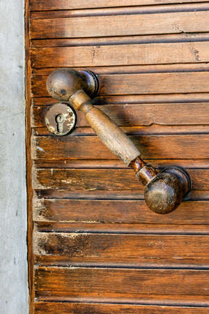 Wooden handle of old vintage wooden brown door close upの写真素材
