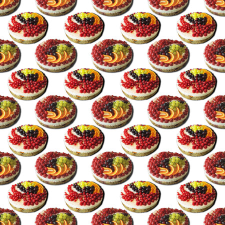 Fresh homemade cake with cream decorated with grapes, red currants, raspberries on a white background as a seamless pattern, isolatedの写真素材