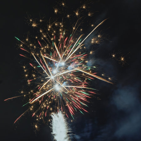 A stunning display of colorful fireworks, lighting up the dark night sky with bright and vivid illuminationの写真素材