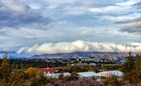 Reykjavik, the capital of Iceland, features vibrant streets and colorful houses amidst stunning mountains. This high-angle image captures the citys unique energy and urban landscape.の写真素材