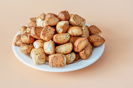 Lithuanian traditional holiday dishes kuciukai, on an orange background with Christmas yeast dough chips and poppiesの写真素材