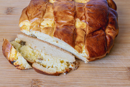 A perfectly baked cake rests on a bamboo cutting board, showing its golden-brown crust. A slice has...