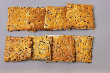 Top view of crispy sugar-free cookies with flax seeds on a gray background