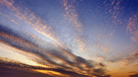 The sky is painted in vibrant colors during sunset, with streaks of orange, pink, and purple...
