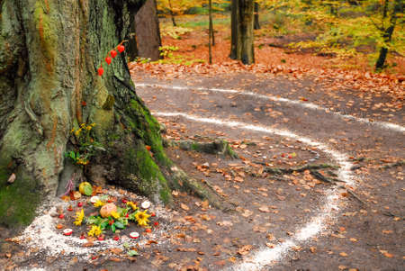 Pagan altar and spiral works outside next to a tree. Wicca and witchcraft.の写真素材