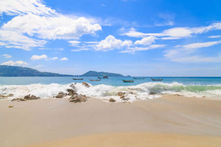 Beautiful beach under sunshine in andaman sea/The beach and blue sky clouds/Fishing boat on the beach in phuket Thailand/At kalim beach neary Patong beach phuket Thailand/の写真素材