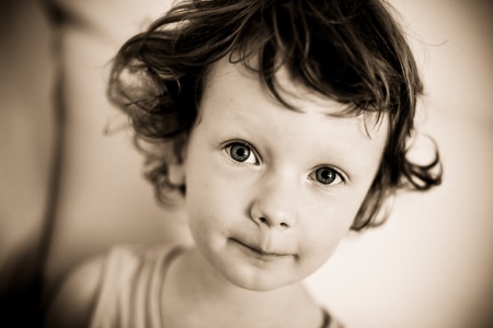 Portrait of a young boy in shades of sephia. Curly hair, curls.の写真素材