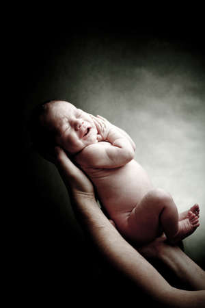 Newborn baby, lying on his fatherの写真素材