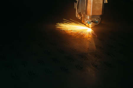 Laser cutting machine cuts the metal with sparks