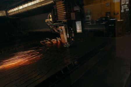 Laser cutting machine cuts the metal with sparks