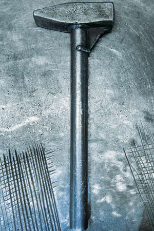 hammer lying on metal tableの写真素材