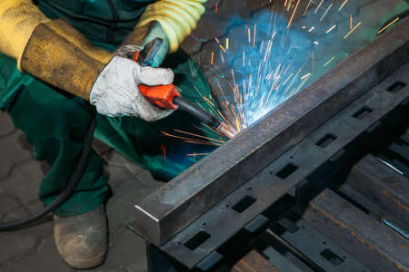 sparks while welder uses torch to welding