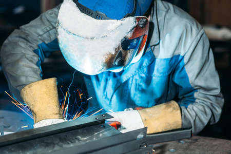 sparks while welder uses torch to welding