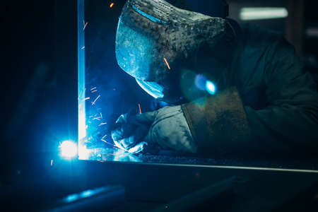sparks while welder uses torch to welding