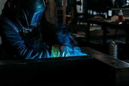 sparks while welder uses torch to weldingの写真素材