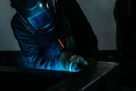 sparks while welder uses torch to welding