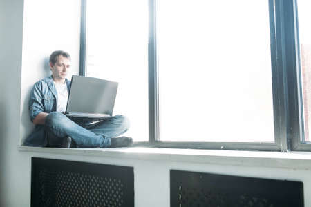 handsome hipster modern man designer working home using laptop at home