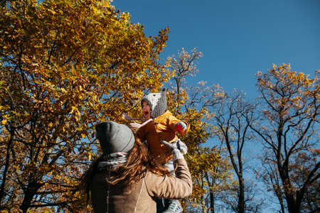 mom throws up and kisses her daughter in the Parkの写真素材