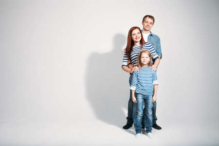 Happy family portrait standing on white background isolatedの写真素材