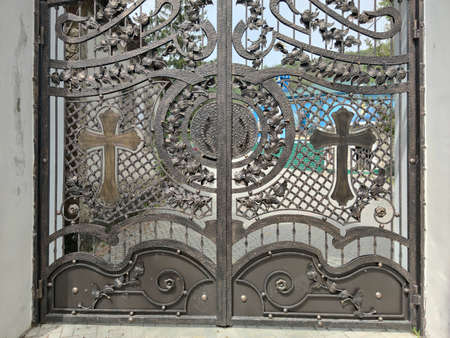 Metal openwork gates to the right-wing monastery. The church building.の写真素材