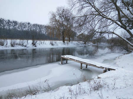 A small pier on the banks of the river. Winter landscape. Ukraine. South bug river