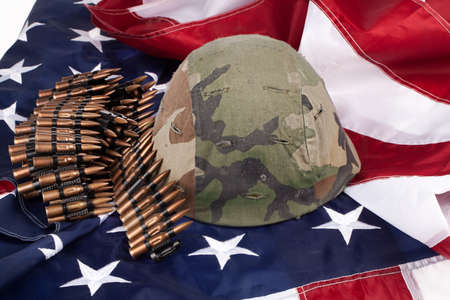 Band with cartdidges and army helmet on an american flagの写真素材