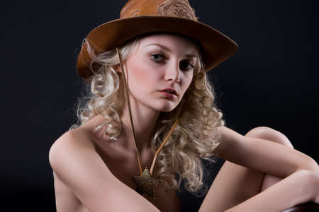 Young blonde woman in a western styleの写真素材