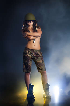 Young attractive woman in military clothingの写真素材