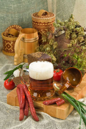 Still life with sausage, beer and vegetablesの写真素材