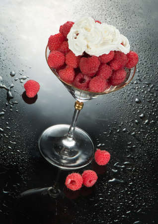 Glass with raspberries and cream