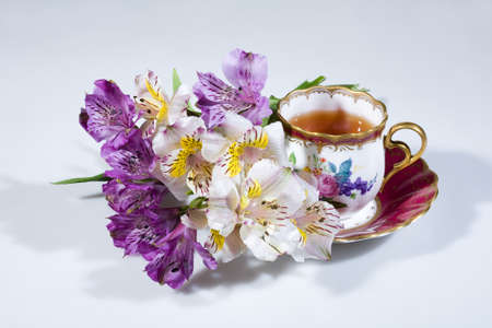 Cup of tea and bouquet of flowersの写真素材